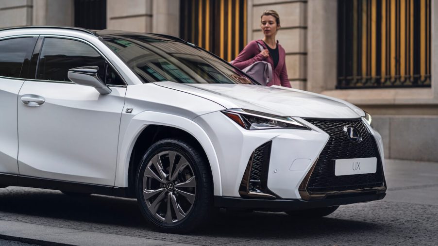 A white 2023 Lexus UX 250h parked on the street. The 2023 Lexus UX resale value is pretty high.