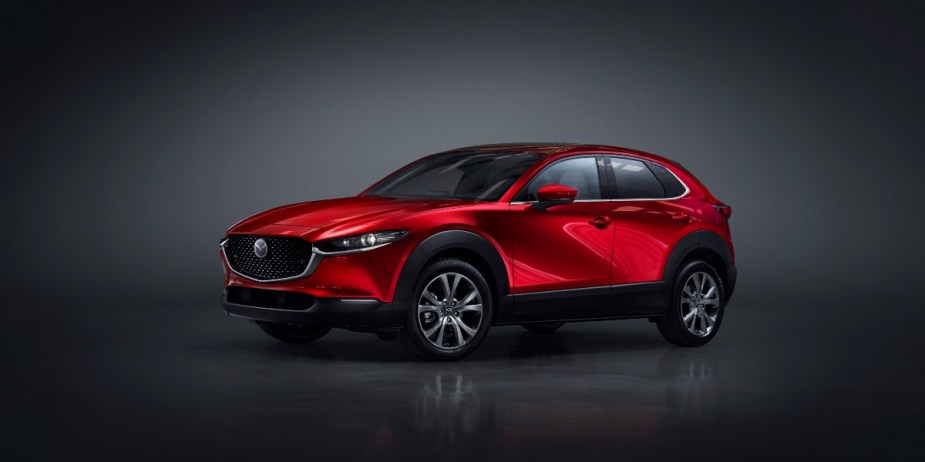 A red 2023 subcompact Mazda SUV is parked. 