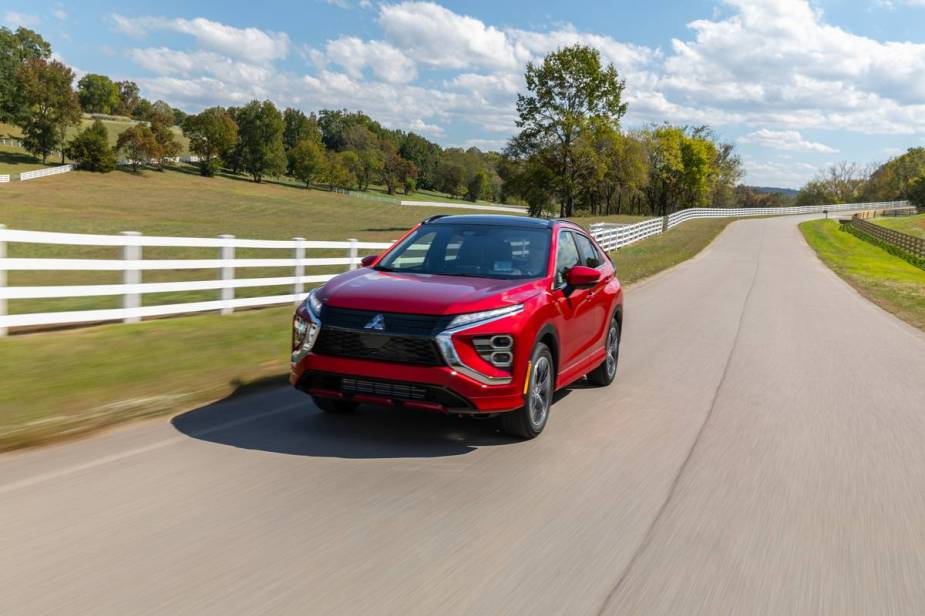 A red Mitsubishi Eclipse Cross driving down an open road.