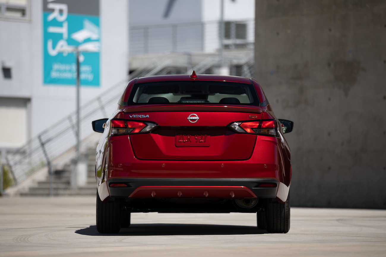 Red 2023 Nissan Versa rear shot. The Versa is the cheapest sedan in 2023.