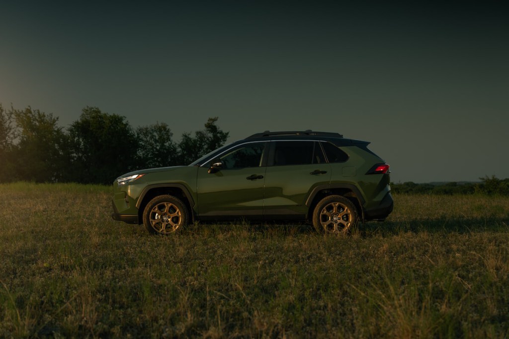 A side view of the 2023 Toyota RAV4 Woodland Edition in a field