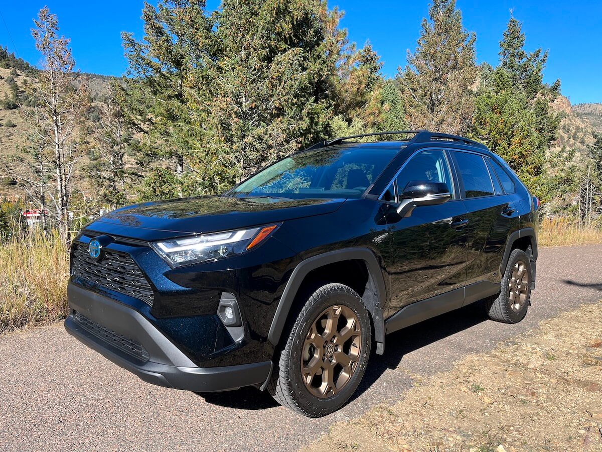 A front corner view of the 2023 Toyota RAV4 Woodland Edition on a mountain road