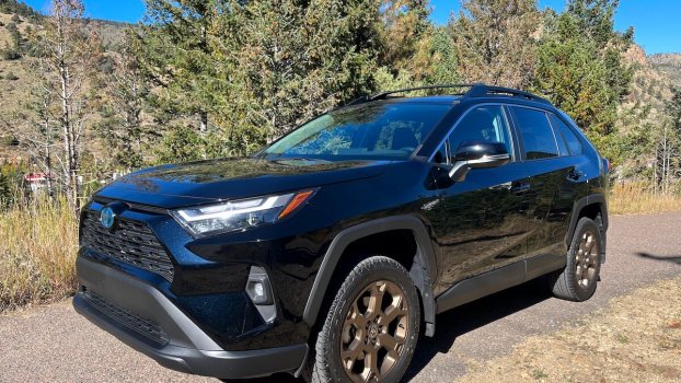 A front corner view of the 2023 Toyota RAV4 Woodland Edition on a mountain road