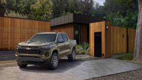 A 2023 Chevrolet Colorado on display in front of a house.