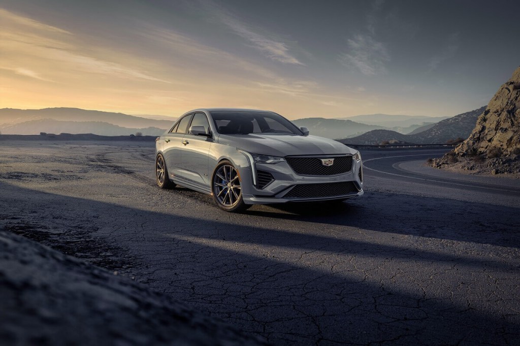 A silver 2023 Cadillac CT4 sits under the sun.