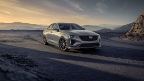 A silver 2023 Cadillac CT4 sits under the sun.