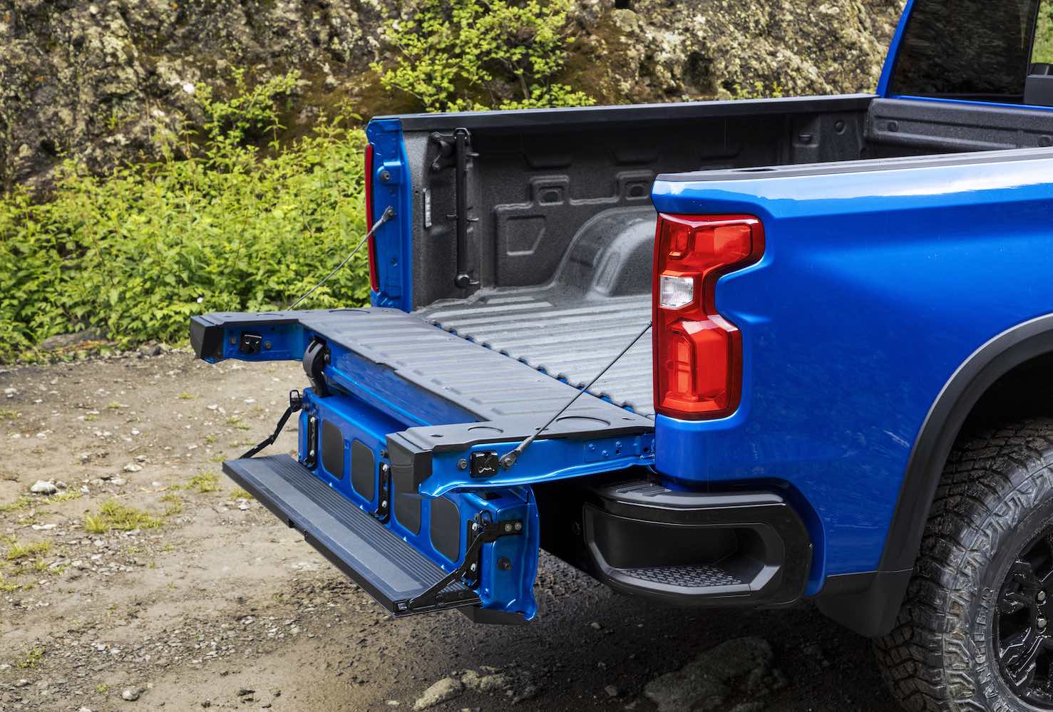 The pickup bed of a blue Chevrolet Silverado 1500 ZR2 parked in the woods.