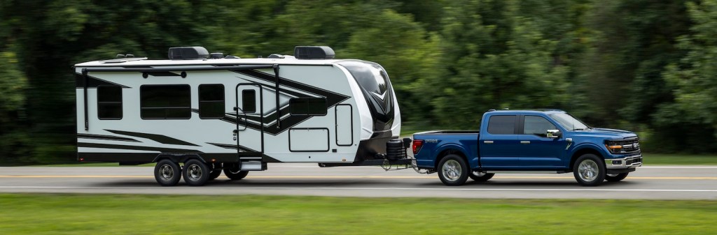 An entry-level Ford F-150 XLT with standard EcoBoost engine towing a large RV trailer.