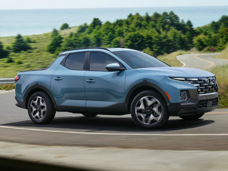 The 2024 Hyundai Santa Cruz driving down the road 