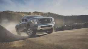 The grille of a 2024 Nissan Titan half-ton pickup truck off-roading through the desert.