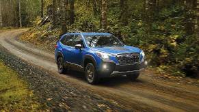 A blue 2024 Subaru Forester Wilderness is driving off-road.