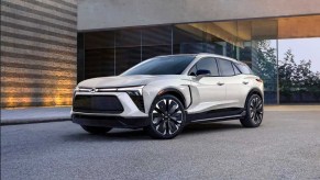White 2024 electric Chevrolet Blazer SUV with building