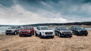 A lineup of different 2024 GMC Terrain SUVs.