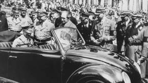 German chancellor Adolf Hitler seated in the very first Volkswagen Beetle model in Stuttgart, Germany