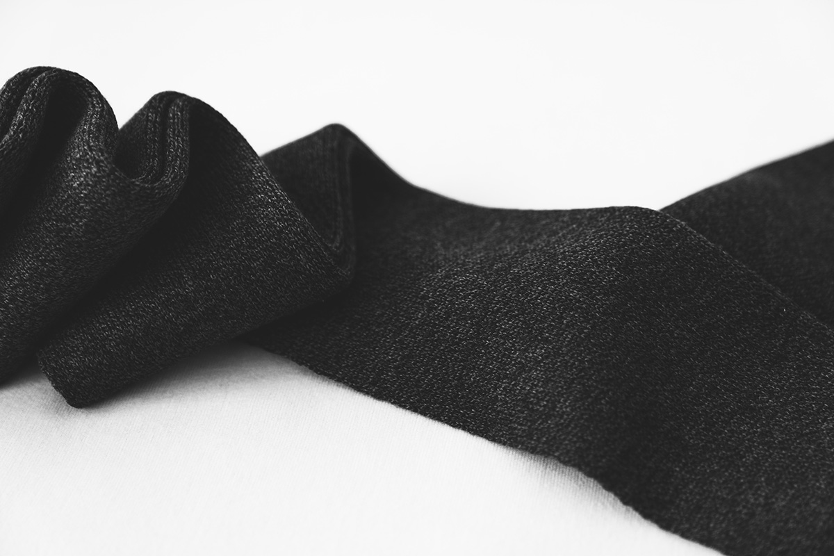 A black sock on a white background because filling a sock with cat litter can help your windows stay defrosted and less foggy in the winter
