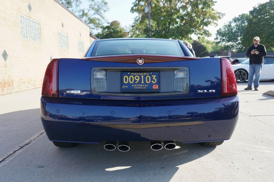 The rear end and tail lights of a used Cadillac XLR luxury sports coupe car.