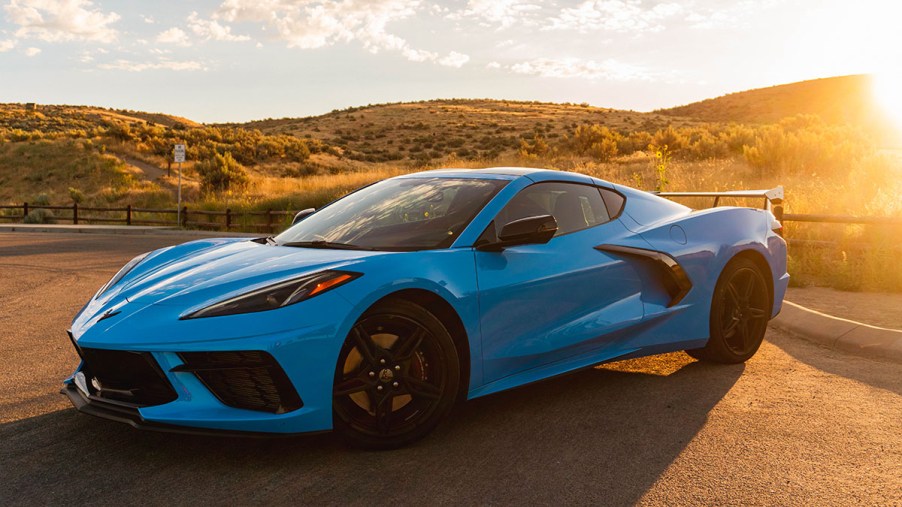 Rapid blue 2021 Chevrolet Corvette coupe 1LT sitting in front of foothills during sunrise front 3/4