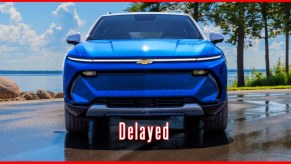 A blue 2024 Chevrolet Equinox midsize electric SUV is parked.