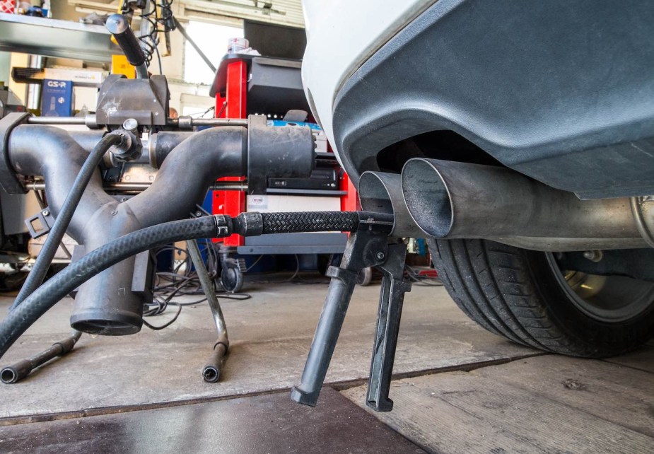 Tailpipe of a diesel Volkswagen failing emissions guidelines because of a defeat device.