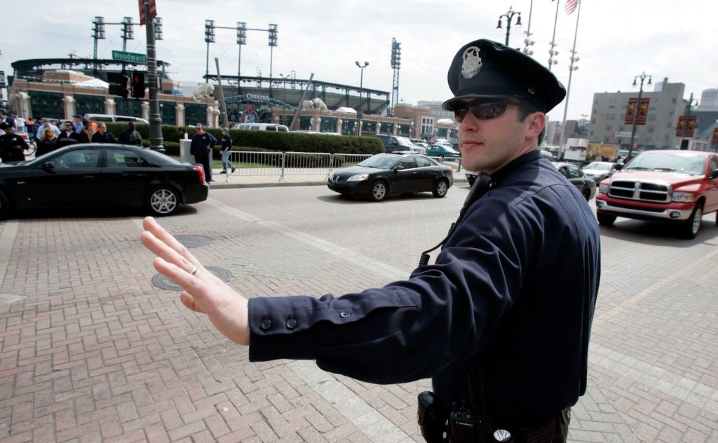 Police officer directing drivers in downtown Detroit, Michigan.