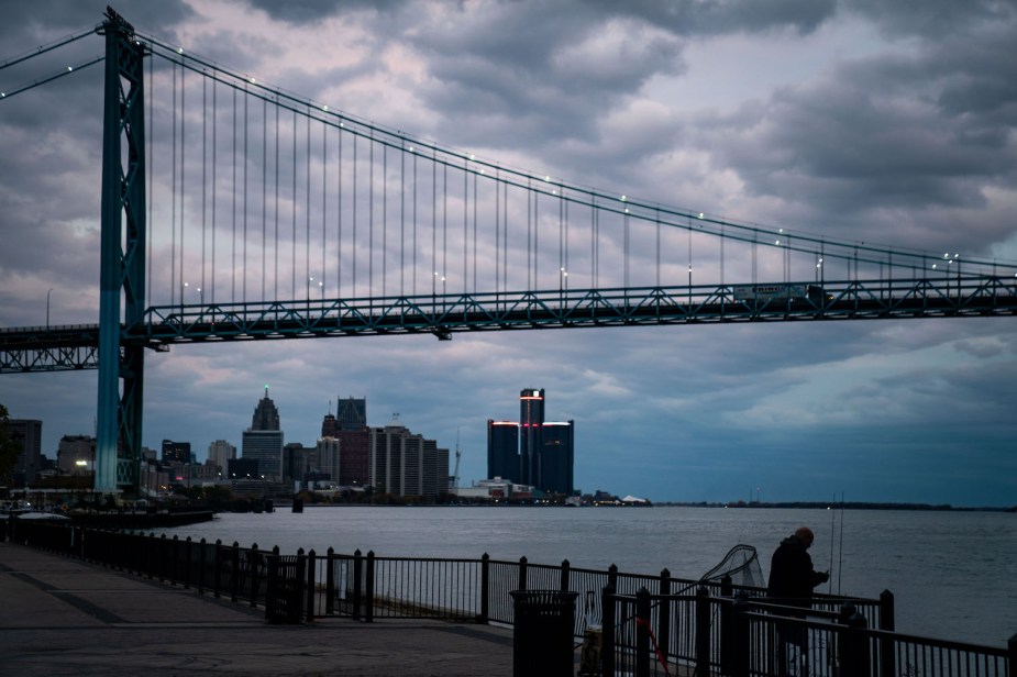 The skyline of Detroit, Michigan, the Ambassador bridge over the river visible in the foreground.