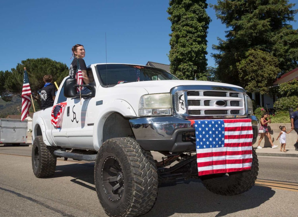 Deleted diesel pickup truck with a lift kit in a July 4th parade.