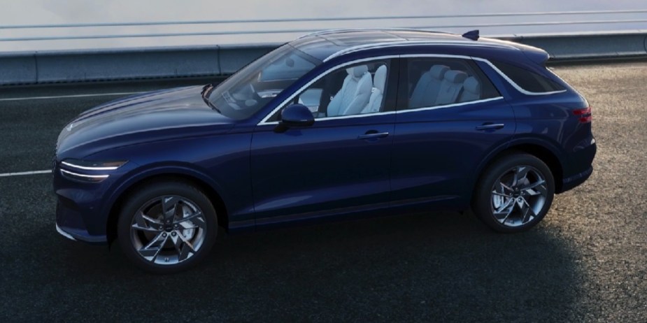 The side profile of a blue Genesis GV80 electric SUV.