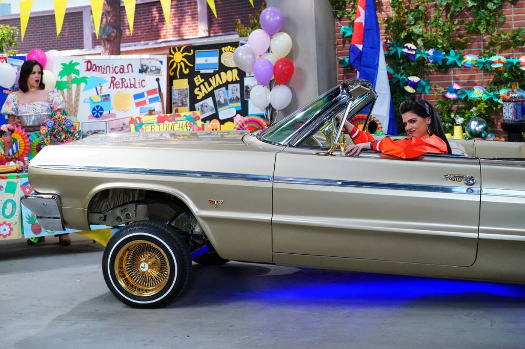 Woman in 1964 Impala lowrider side view