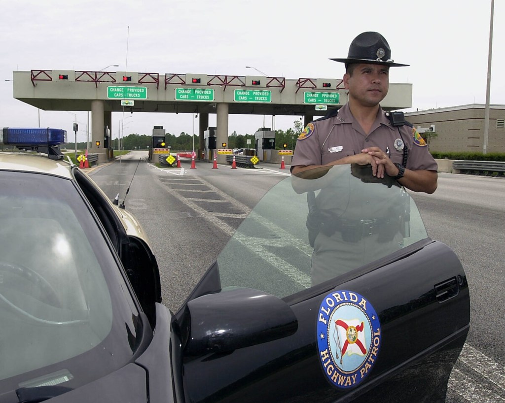 Florida Highway Patrolman next to his car 