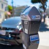 A lone San Francisco parking meter with car in background