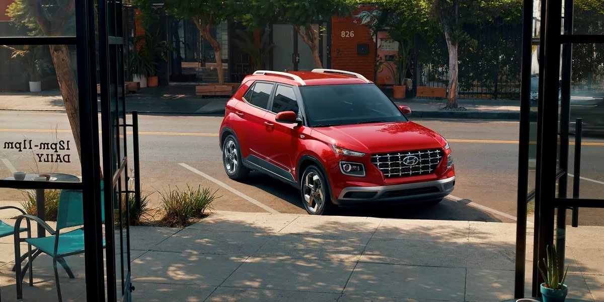 A red 2023 Hyundai Venue subcompact SUV is parked.