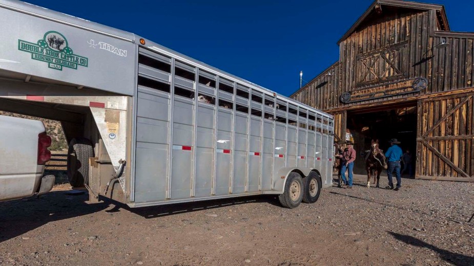 Aluminum cattle trailer backed up to a barn at a Colorado ranchers