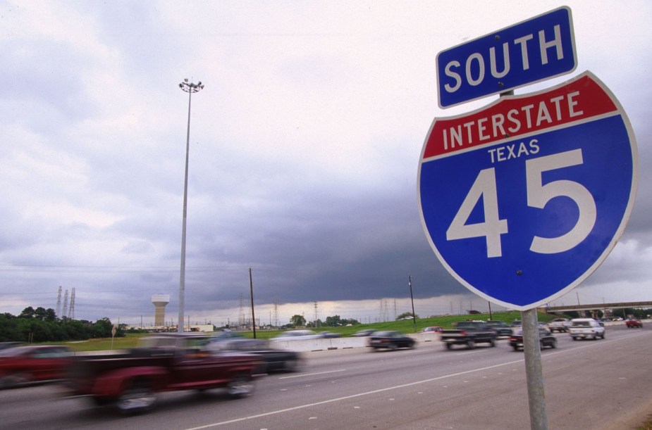 Cars blur down the highway, a sign for interstate 45 in the foreground.