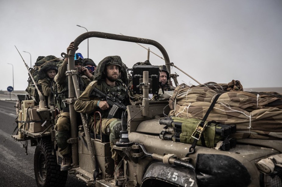 IDF troops in an open-top military Jeep driving to Gaza during the Hamas conflict.