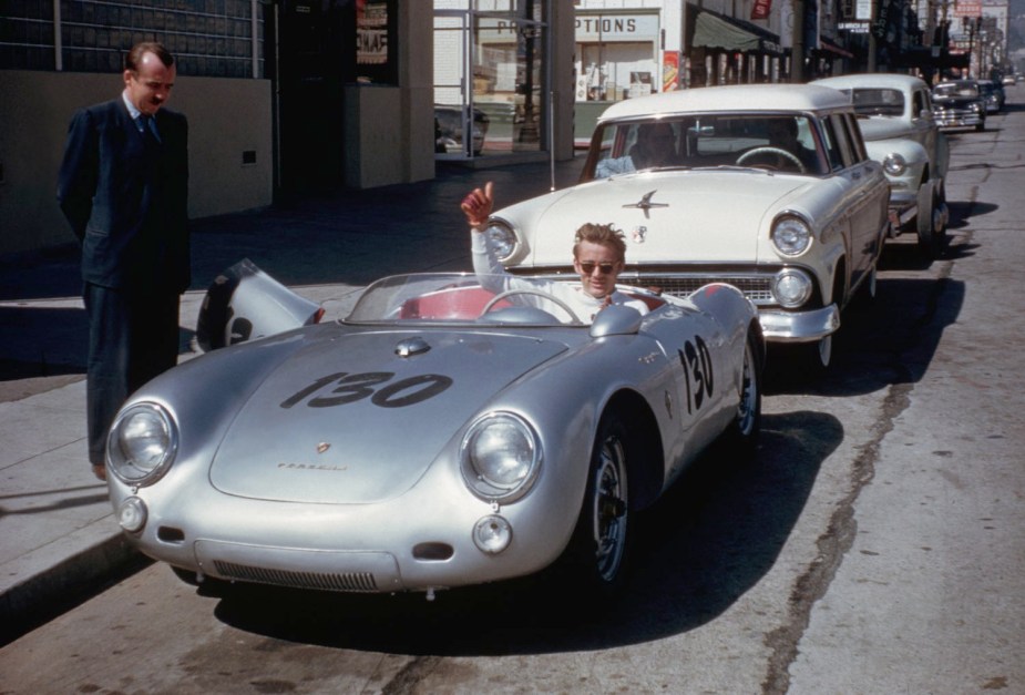 James Dean gives the thumbs up from his parked Porsche spyder while parked in Hollywood.
