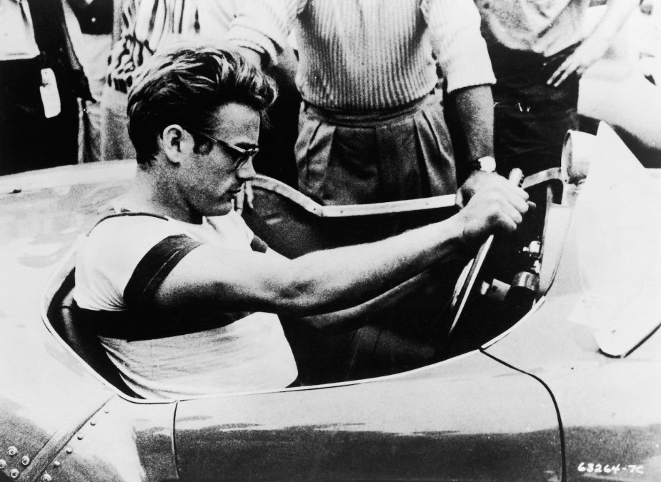 James Dean sits at the wheel of a sports car before a race in California.
