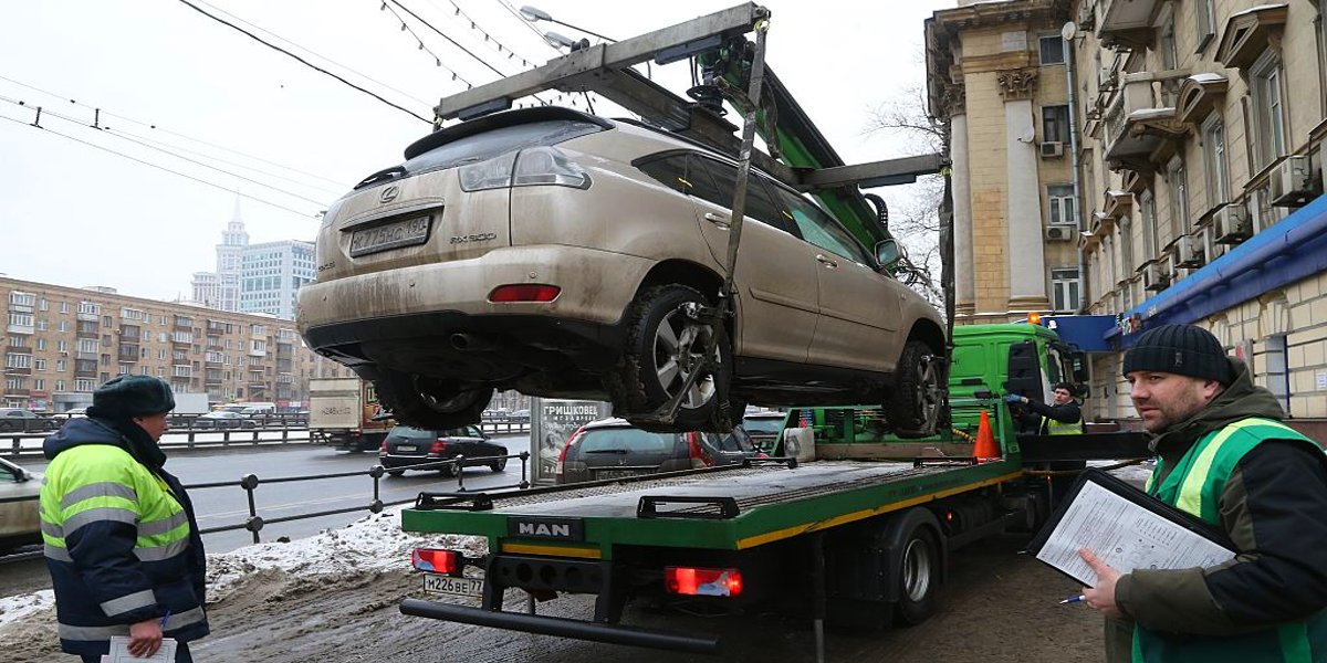 A Lexus SUV is getting towed.