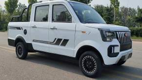 A white ChangLiEV mini electric truck parked on a road