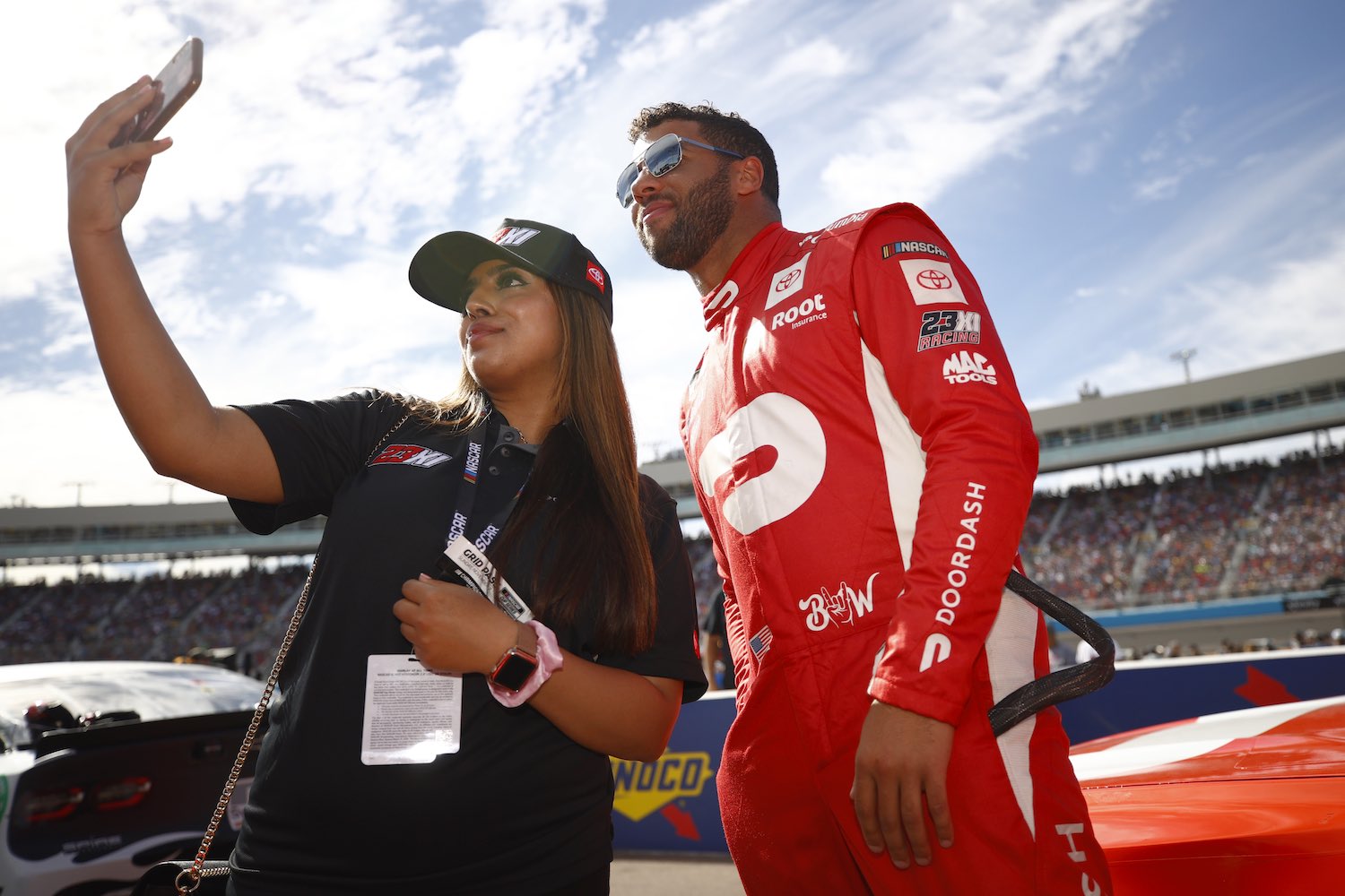Bubba Wallace and a Millennial fan take a selfie during a NASCAR cup race in Arizona.