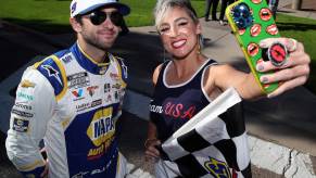 NASCAR fan takes a selfie with driver Chase Elliott during a race event.