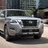A gray 2023 Nissan Armada full-size SUV is driving on the road.