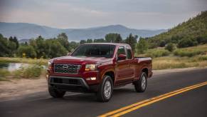 A Nissan Frontier driving down the road.
