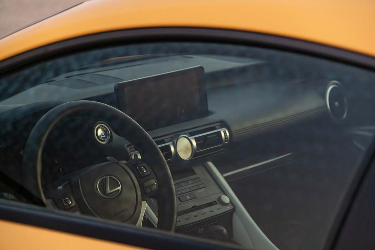 Interior shot through window of 2023 Lexus RC F Carbon Package in metallic yellow paint