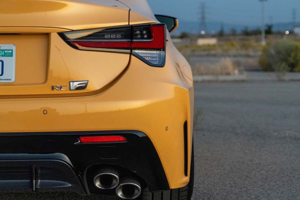Passenger side rear tail light of the 2023 Lexus RC F with Carbon Package in metallic yellow parked during sunset in southern California