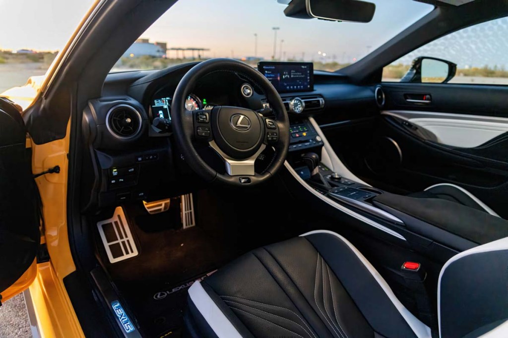 Interior of 2023 Lexus RCF facing dashboard shot through driver's side open door