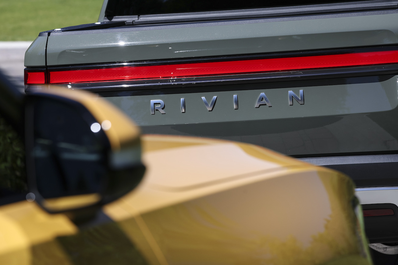 The Rivian logo is seen on a Rivian R1T Truck parked outside the Allen & Company Sun Valley Conference. The cheapest Rivian R1T price is pretty high still.