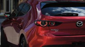 A red Mazda3 Hatchback on display.
