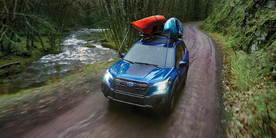 A blue 2024 Subaru Forester Wilderness is driving off-road. 