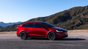 A red 2023 Tesla Model X is parked.