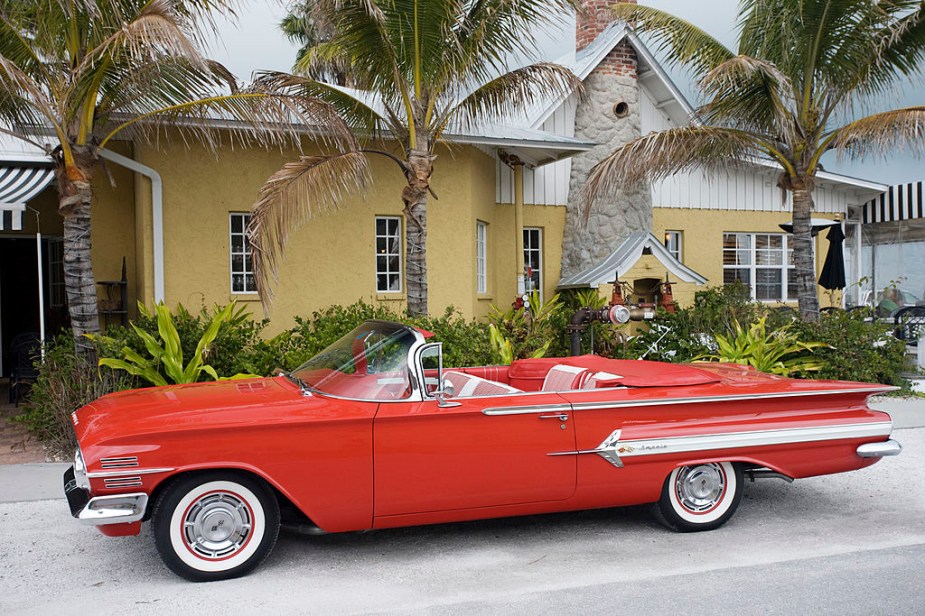 Red 1960 Chevrolet Impala convertible with top down